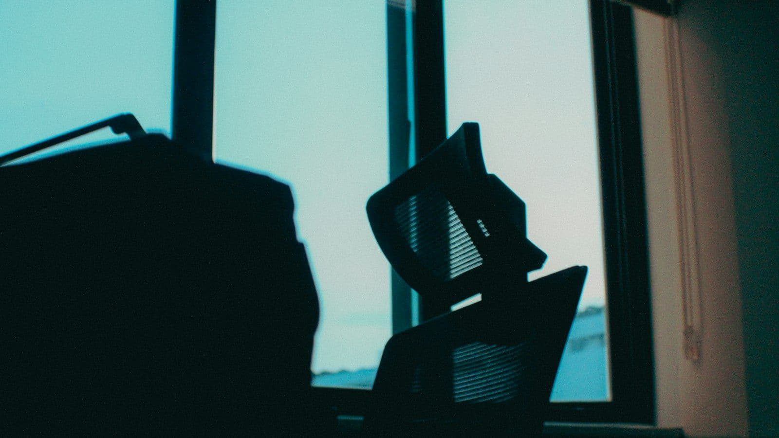 Empty office chair against a window